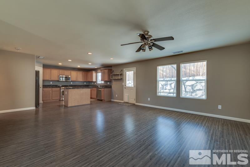 2924 Bryan Street Reno, NV 89503 - Photo 6 of 23 a view of an empty room with wooden floor and a window