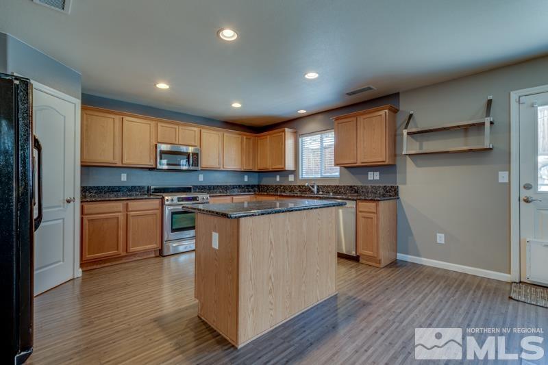 2924 Bryan Street Reno, NV 89503 - Photo 8 of 23 a kitchen with granite countertop wooden floors stainless steel appliances and window