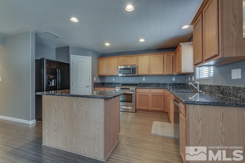 2924 Bryan Street Reno, NV 89503 - Photo 9 of 23 a kitchen with stainless steel appliances granite countertop a stove a sink and a refrigerator