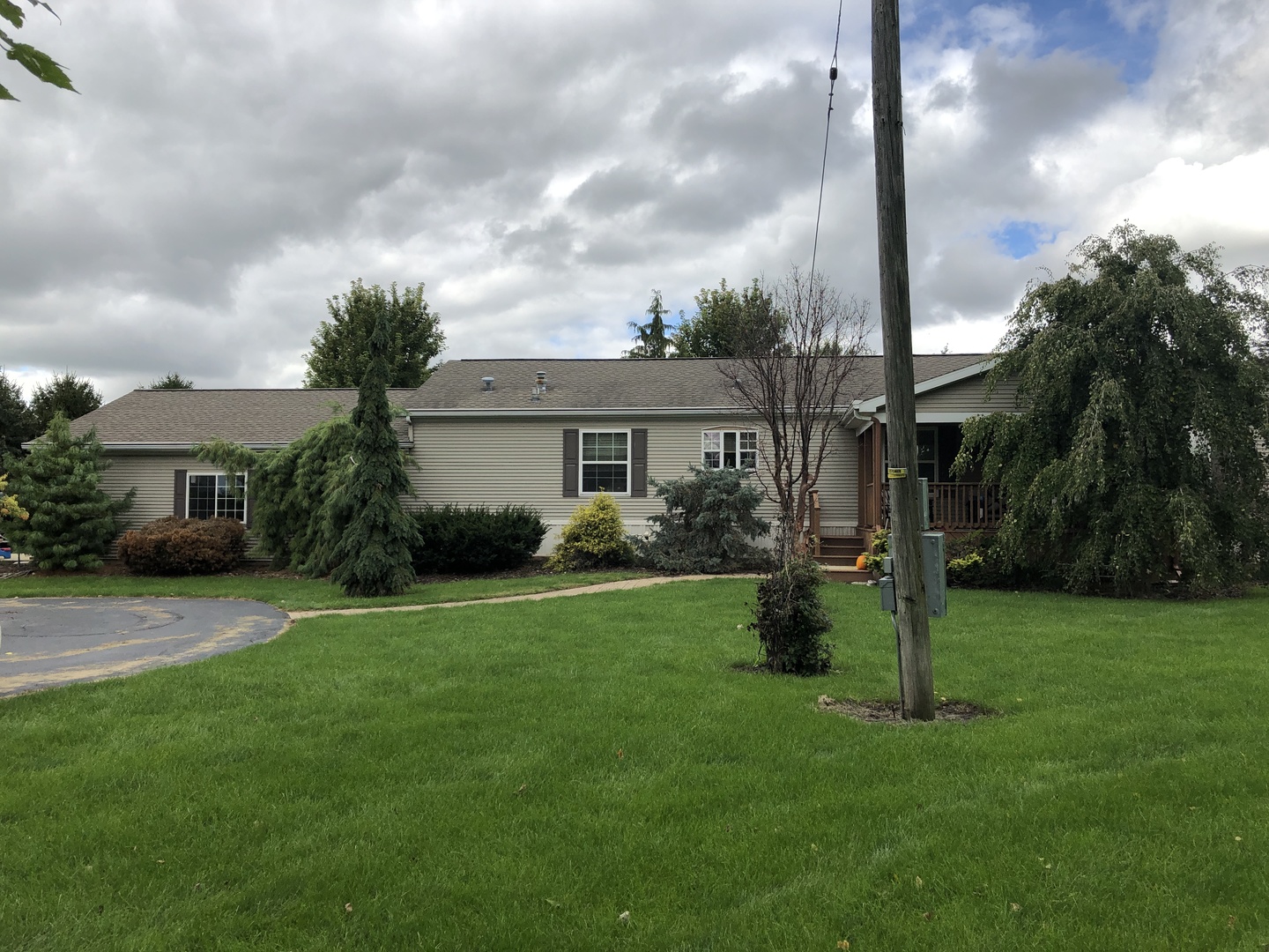 a very nice looking house with a big yard and a large trees with a big yard