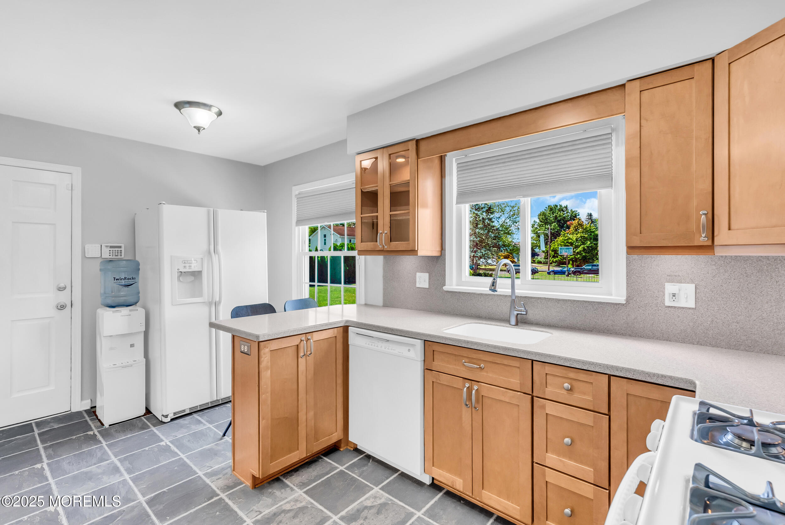 11 Pinewood Avenue West Long Branch, NJ 07764 - Photo 11 of 39 a kitchen with a sink window and cabinets