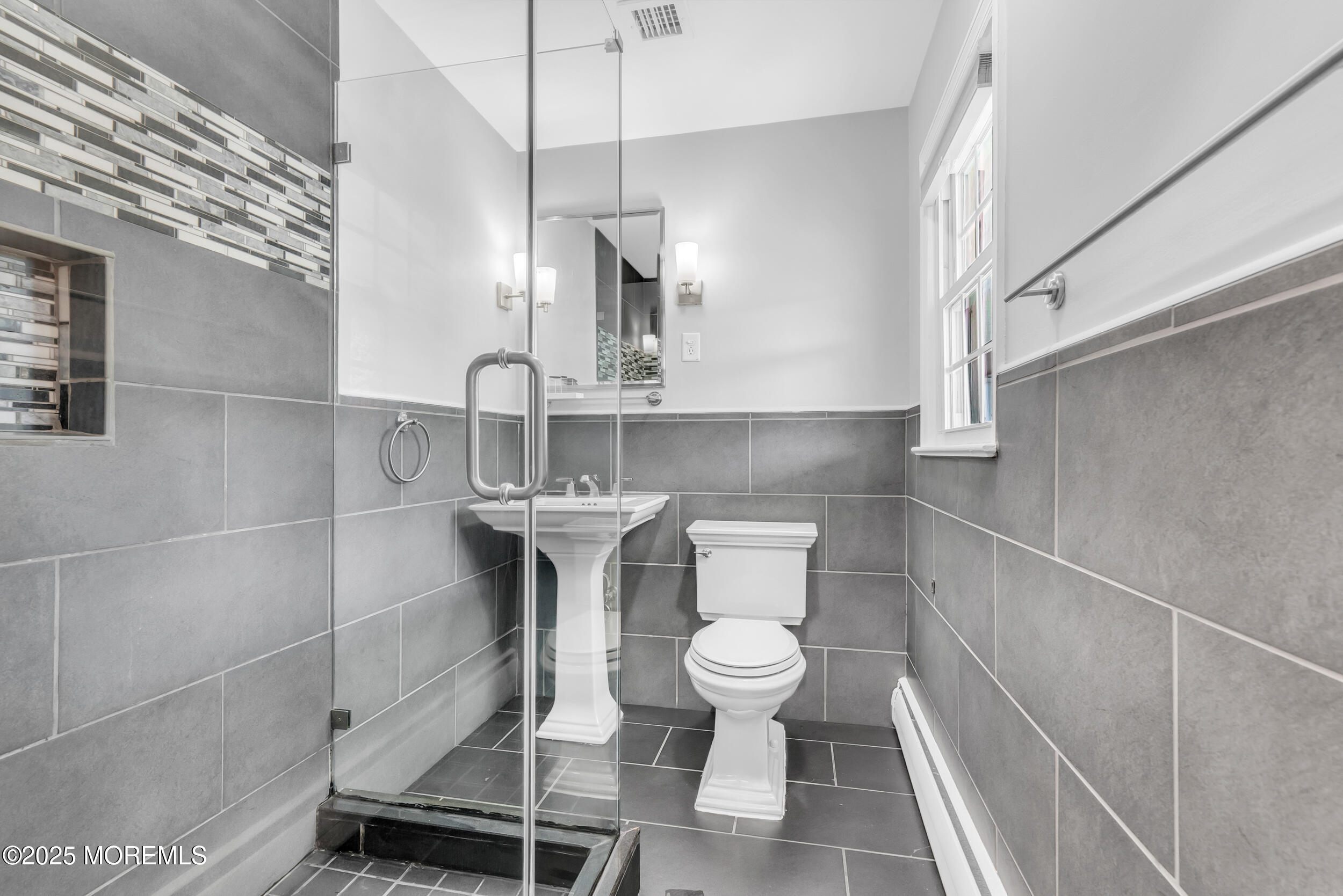 11 Pinewood Avenue West Long Branch, NJ 07764 - Photo 22 of 39 a bathroom with a sink a toilet and mirror