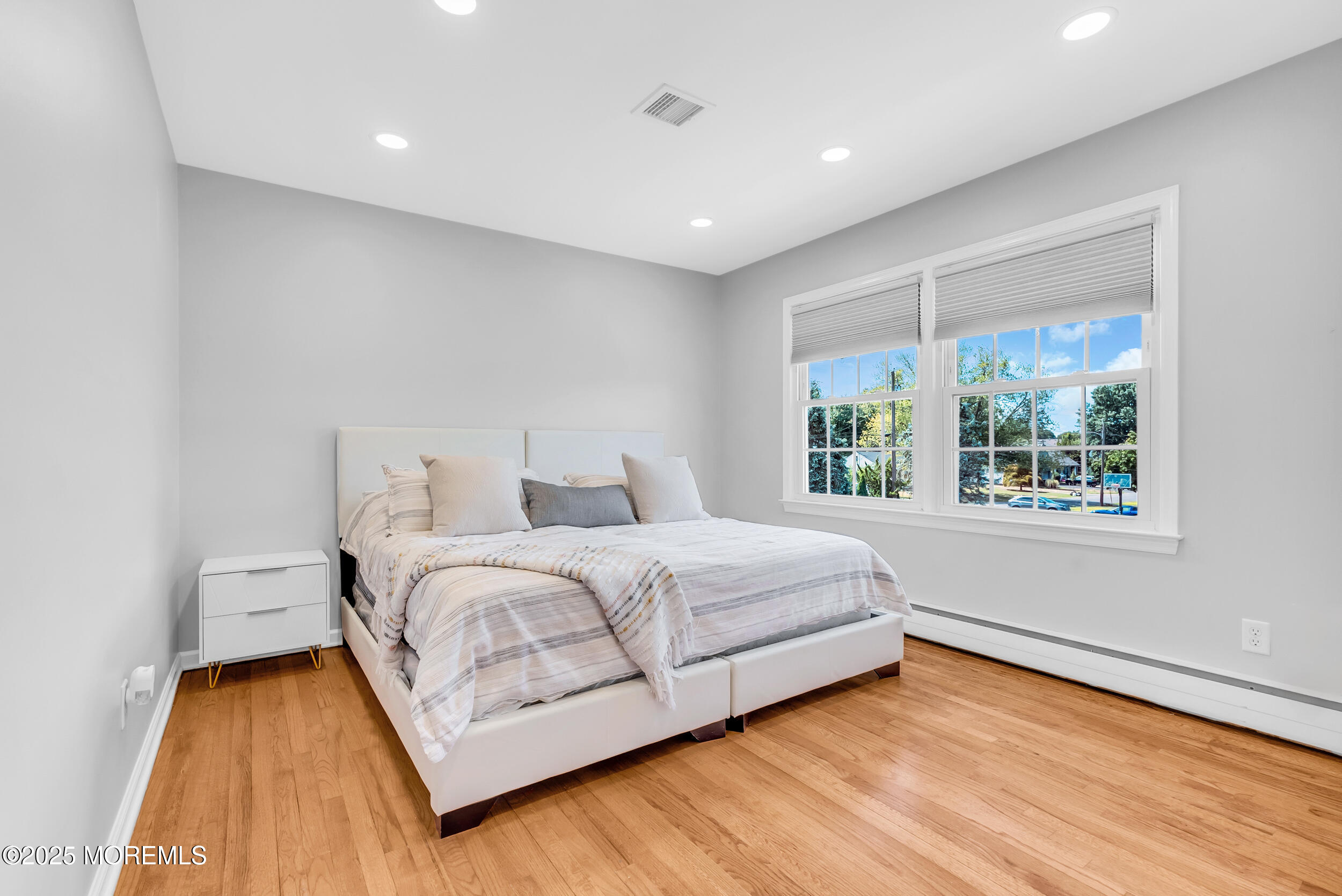 11 Pinewood Avenue West Long Branch, NJ 07764 - Photo 29 of 39 a spacious bedroom with a bed and a large window