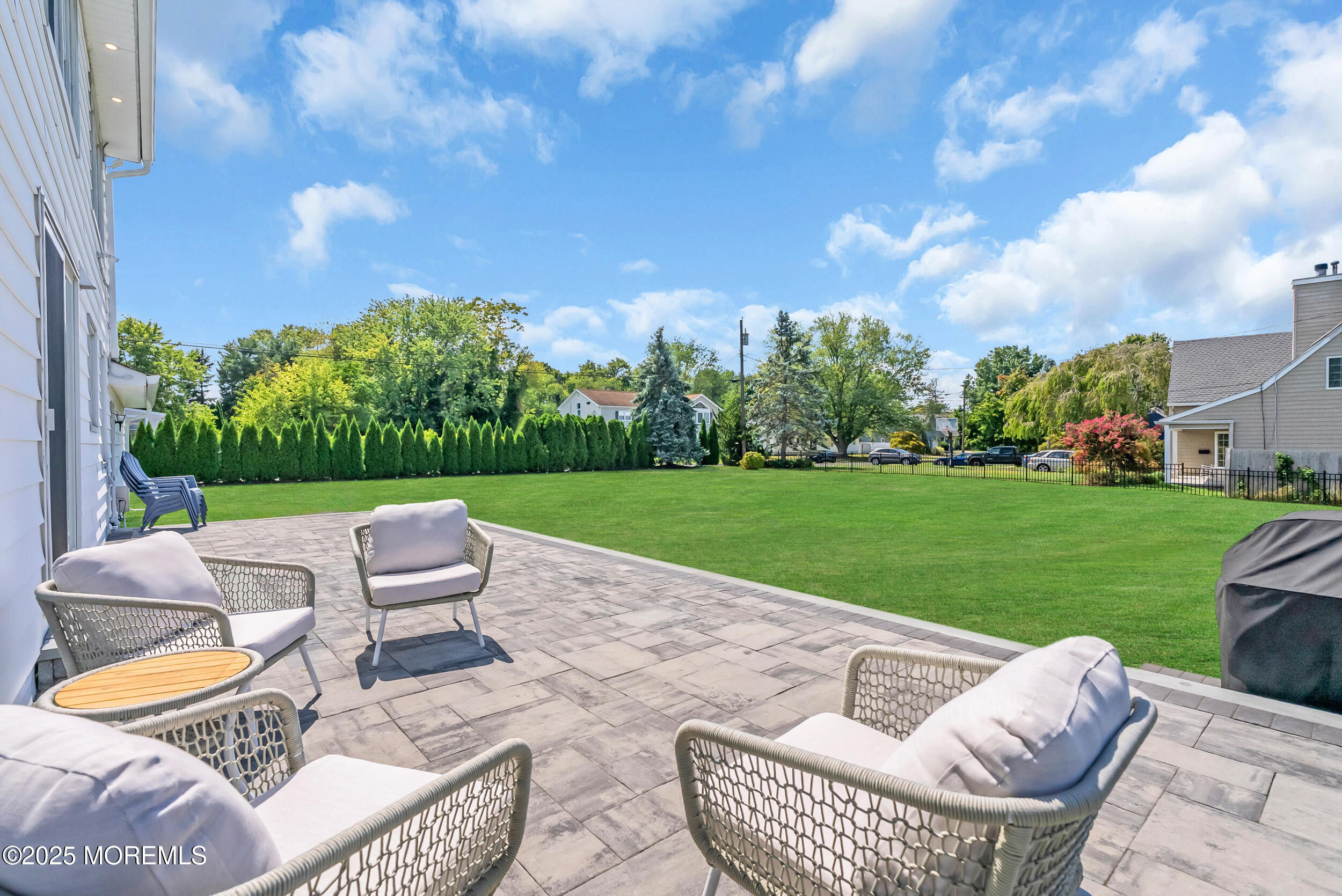 11 Pinewood Avenue West Long Branch, NJ 07764 - Photo 35 of 39 a view of a patio with couches chairs and a yard