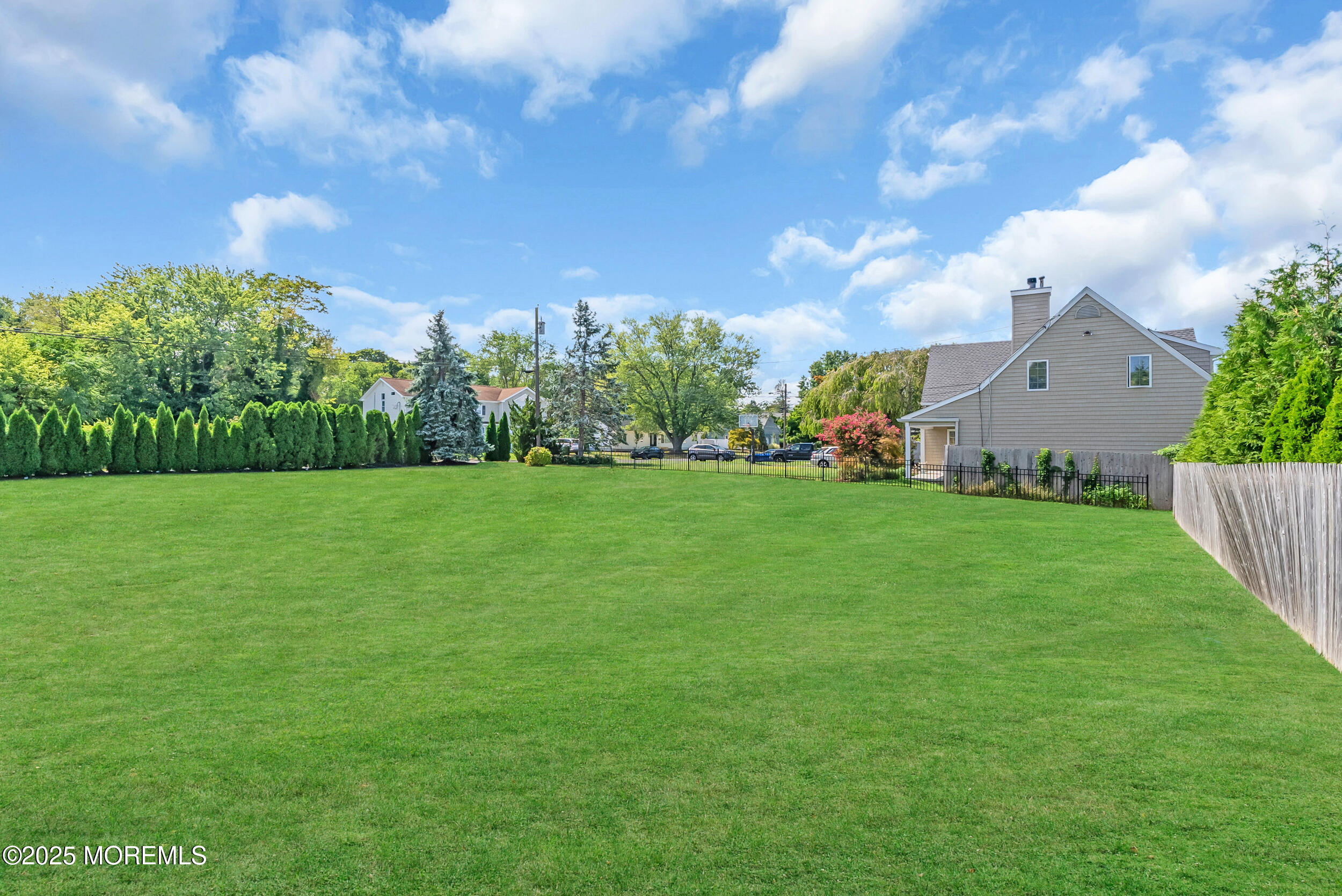 11 Pinewood Avenue West Long Branch, NJ 07764 - Photo 36 of 39 a view of a garden with a building in the background