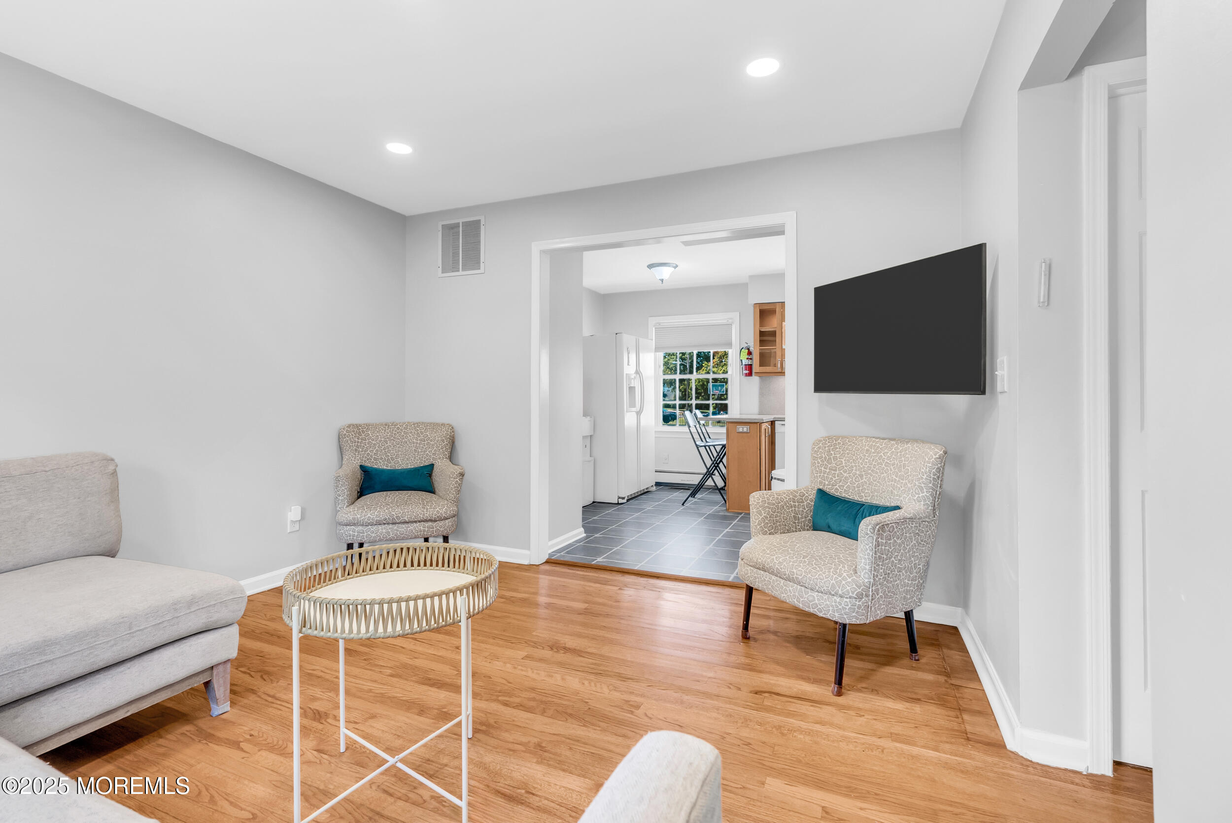 11 Pinewood Avenue West Long Branch, NJ 07764 - Photo 8 of 39 a living room with furniture and a flat screen tv