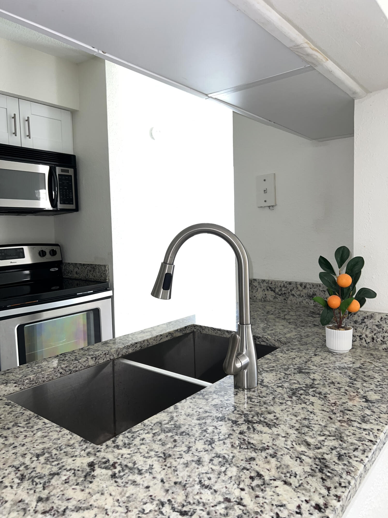 899 Riverside Drive, Unit 620 Coral Springs, FL 33071 - Photo 9 of 46 a kitchen with stainless steel appliances kitchen island a stove a sink and a microwave