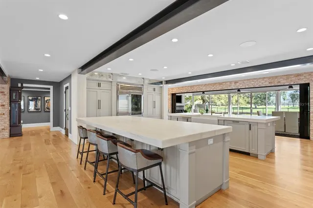 a spacious bathroom with a tub double vanity sink a mirror and a bathtub