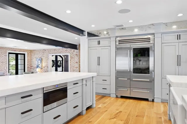 a bathroom with a granite countertop sink mirror and toilet