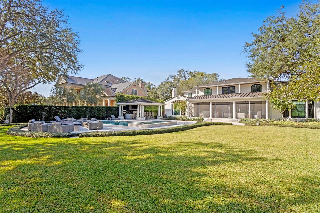 1002 South Frankland Road Tampa, FL 33629 - Photo 74 of 88 a view of a swimming pool with a lounge chairs in front of house
