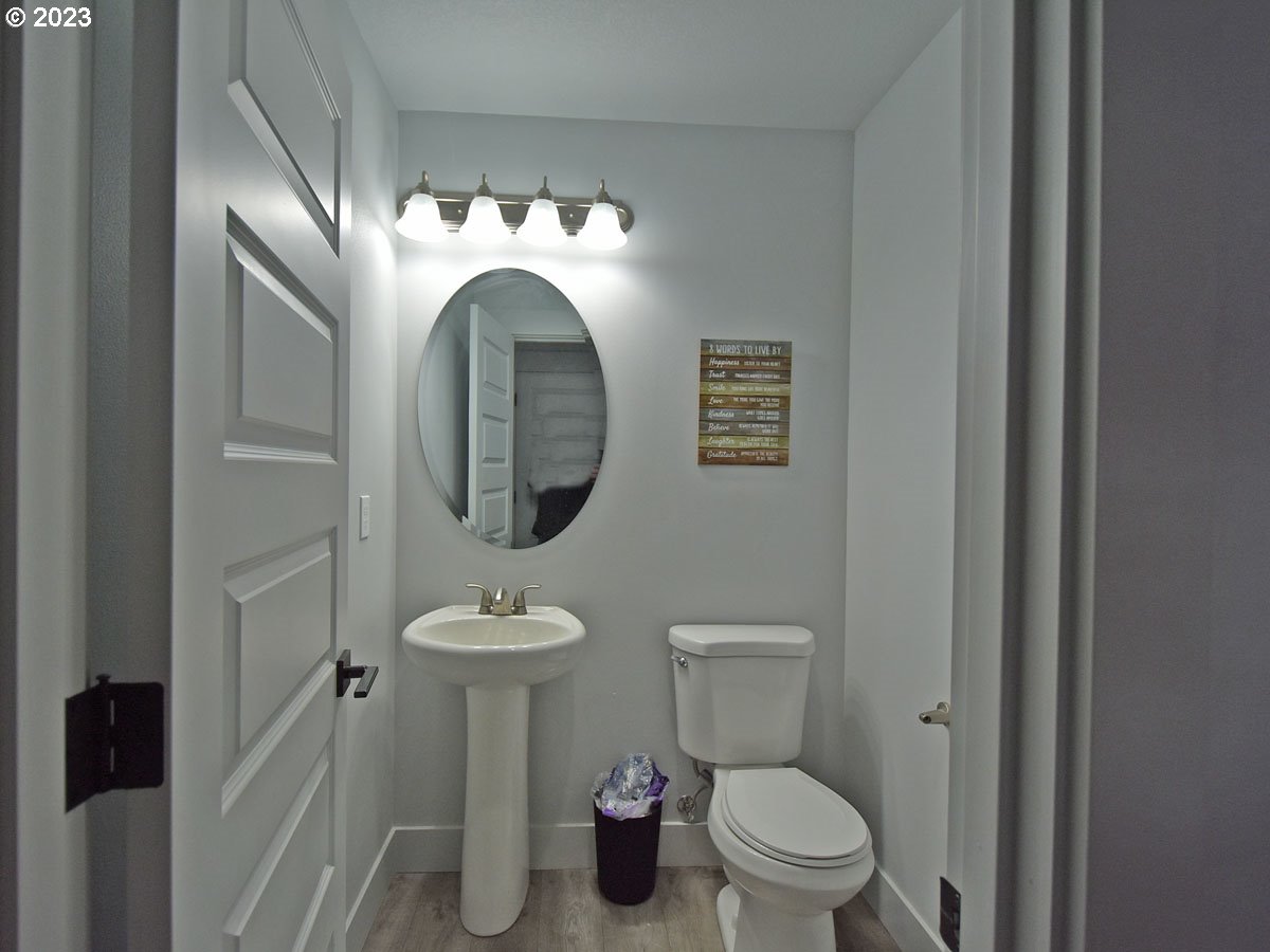 306 Oak Street Winlock, WA 98596 - Photo 16 of 35 a bathroom with a toilet sink and mirror
