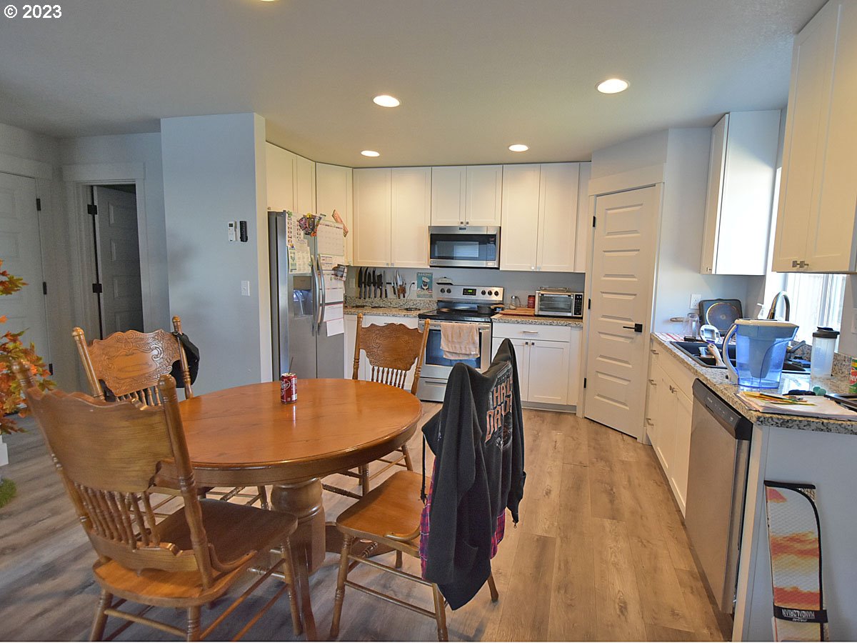 306 Oak Street Winlock, WA 98596 - Photo 18 of 35 a kitchen with a dining table chairs and refrigerator