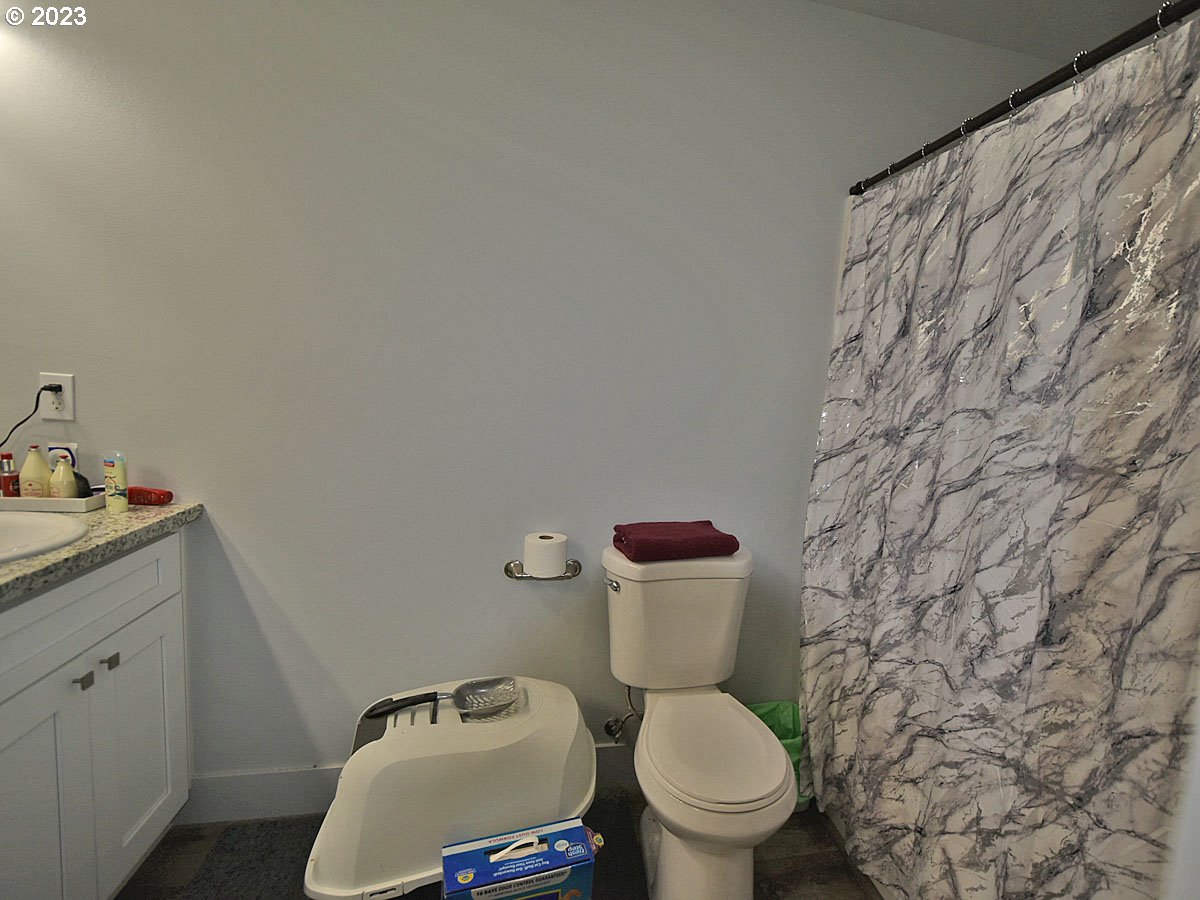 306 Oak Street Winlock, WA 98596 - Photo 24 of 35 a white toilet sitting next to a bathroom sink