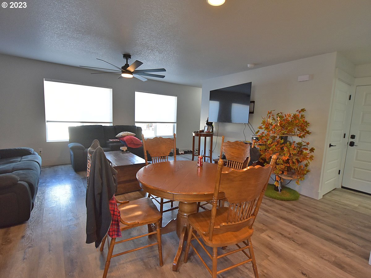 306 Oak Street Winlock, WA 98596 - Photo 30 of 35 a dining room with furniture a chandelier and wooden floor
