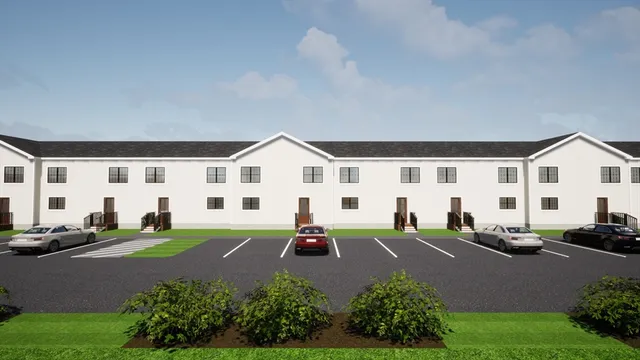 a front view of a white house with a yard