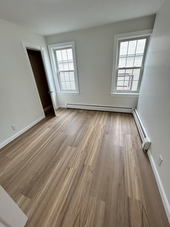 0 Main Street, Unit 1 Brockton, MA 02301 - Photo 6 of 9 an empty room with wooden floor and windows
