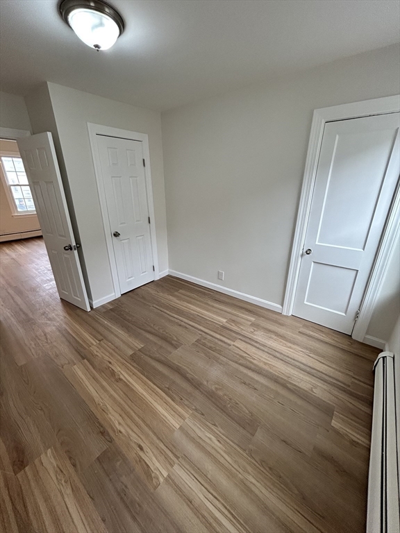 0 Main Street, Unit 1 Brockton, MA 02301 - Photo 7 of 9 a view of a room with wooden floor and white walls