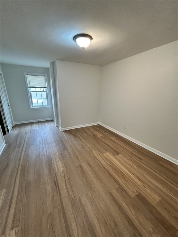 0 Main Street, Unit 1 Brockton, MA 02301 - Photo 8 of 9 wooden floor in an empty room with a window