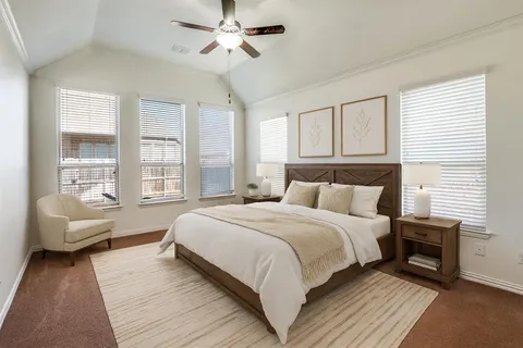 a bedroom with a large bed couch and a window