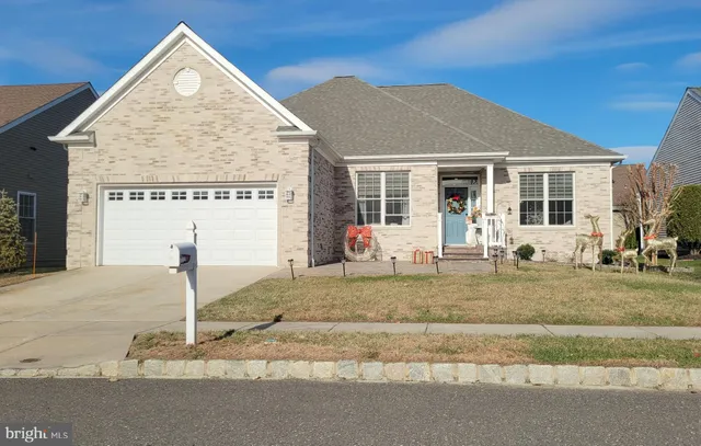 a view of a house with a yard and table and chairs