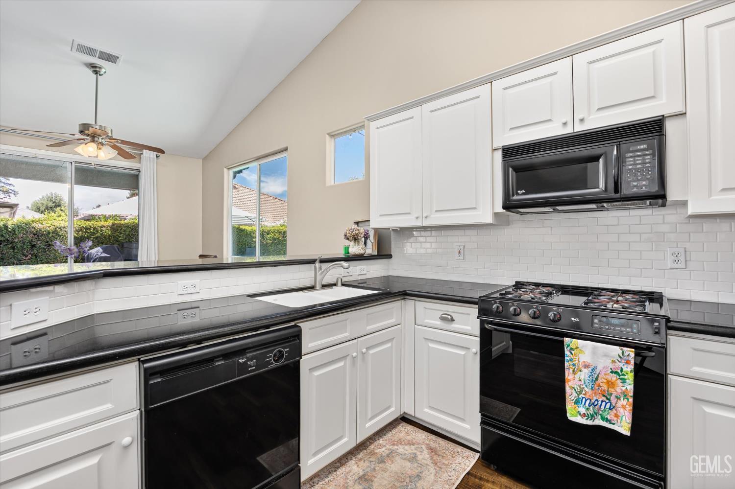Undisclosed Address Bakersfield, CA 93311 - Photo 22 of 39 a kitchen with stainless steel appliances granite countertop a stove a microwave and sink