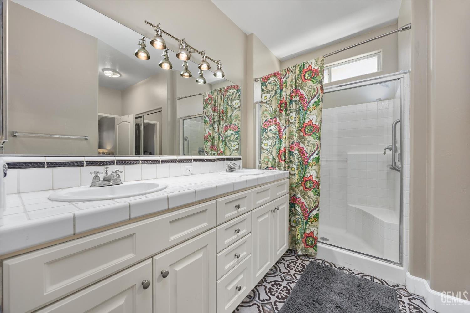 Undisclosed Address Bakersfield, CA 93311 - Photo 27 of 39 a bathroom with a double vanity sink mirror and shower