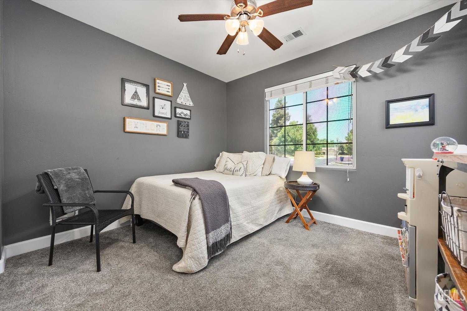 Undisclosed Address Bakersfield, CA 93311 - Photo 28 of 39 a bedroom with a bed and a chandelier