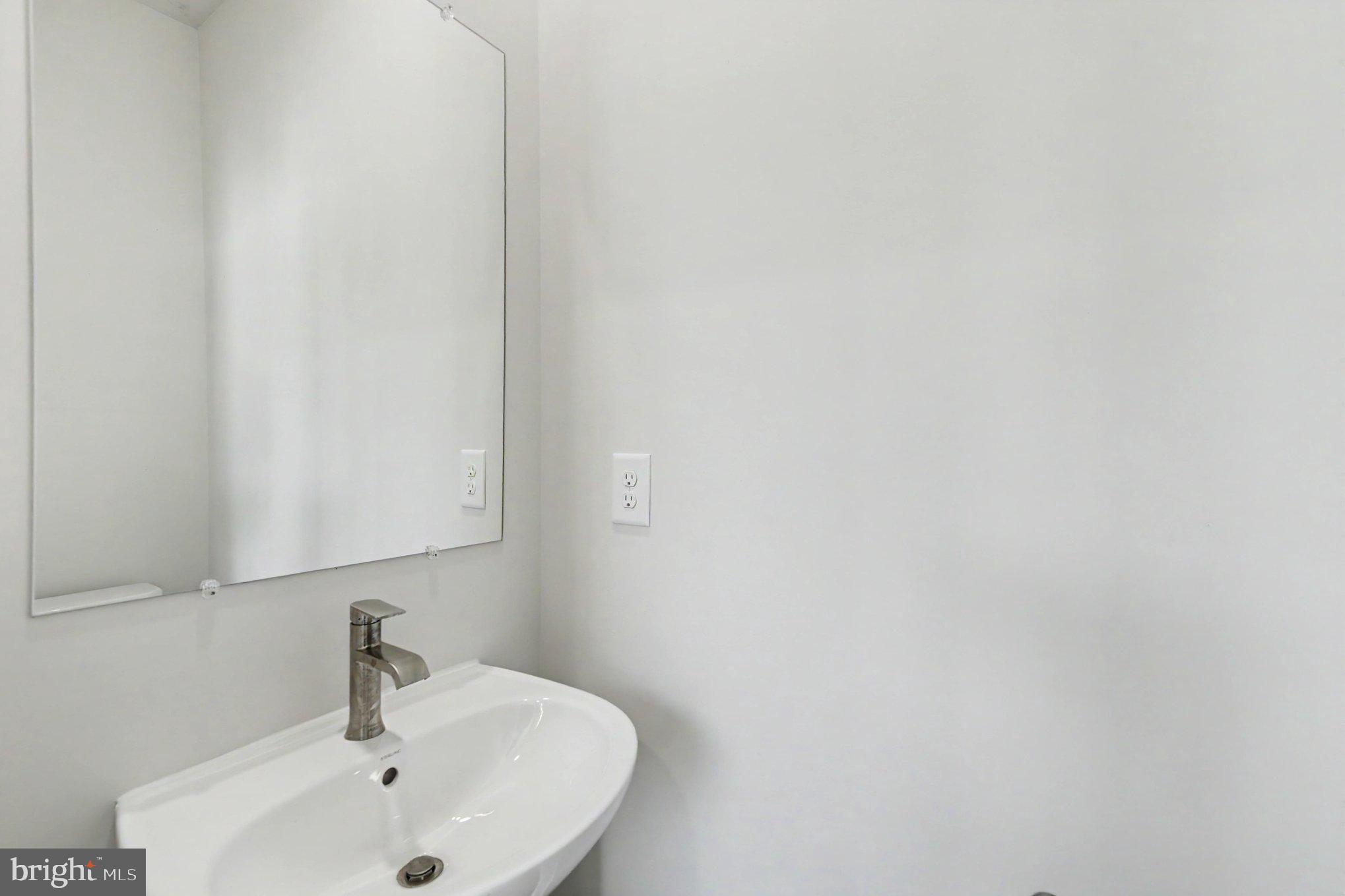 238 Waterstone Road Essex, MD 21221 - Photo 22 of 39 a bathroom with a sink and mirror