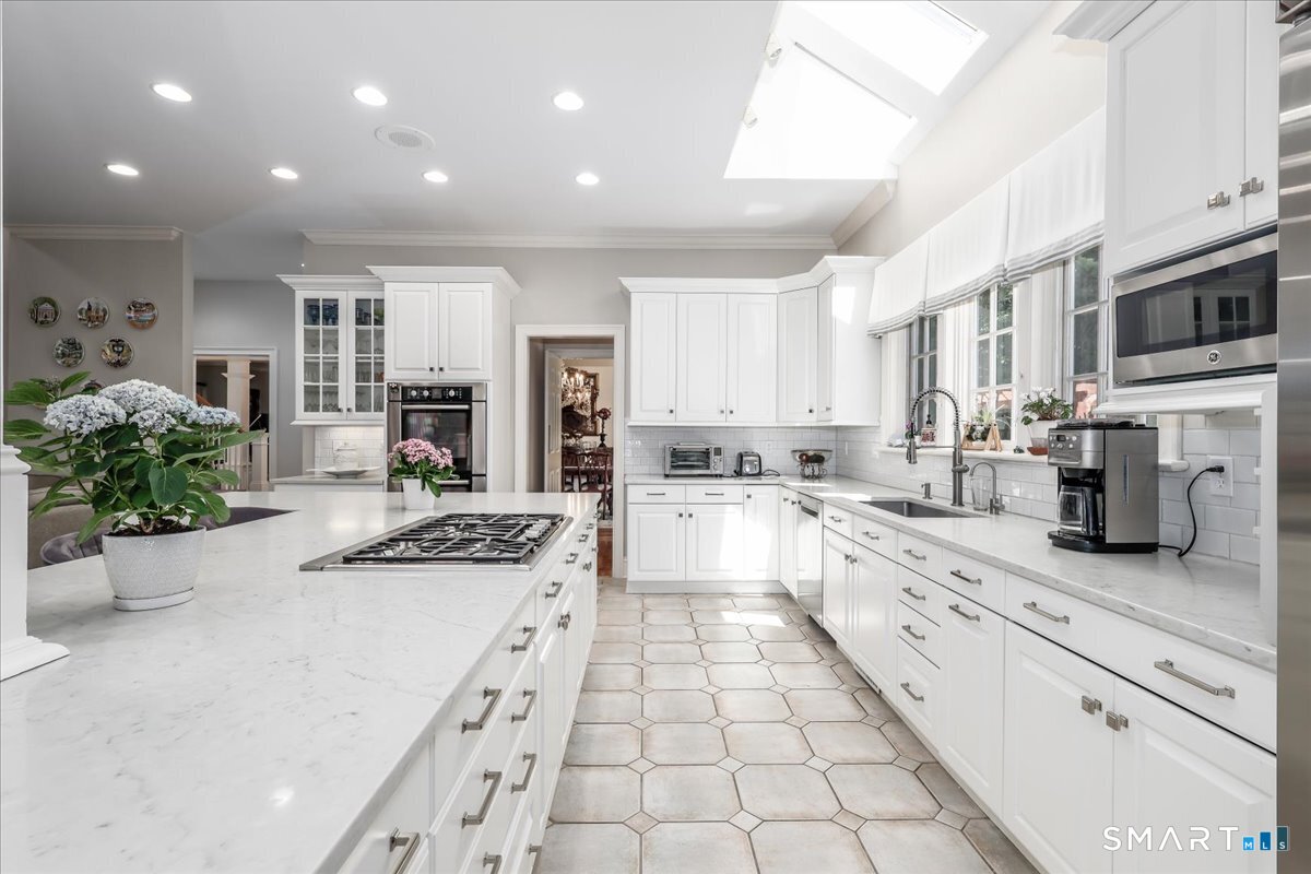 170 Branchville Road Ridgefield, CT 06877 - Photo 12 of 36 White cabinetry with double ovens, two dishwashers, subzero Refrigerator, Granite counters, Skylight. Pantry. Perfect for year around entertaining!