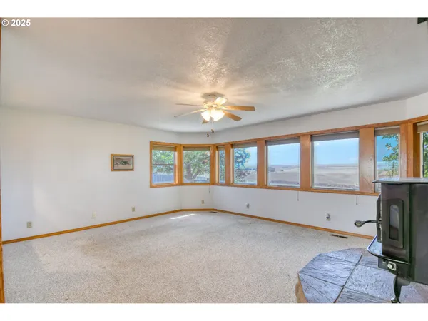 a living room with fireplace furniture and a large window