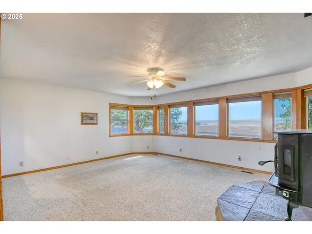 a living room with fireplace furniture and a large window