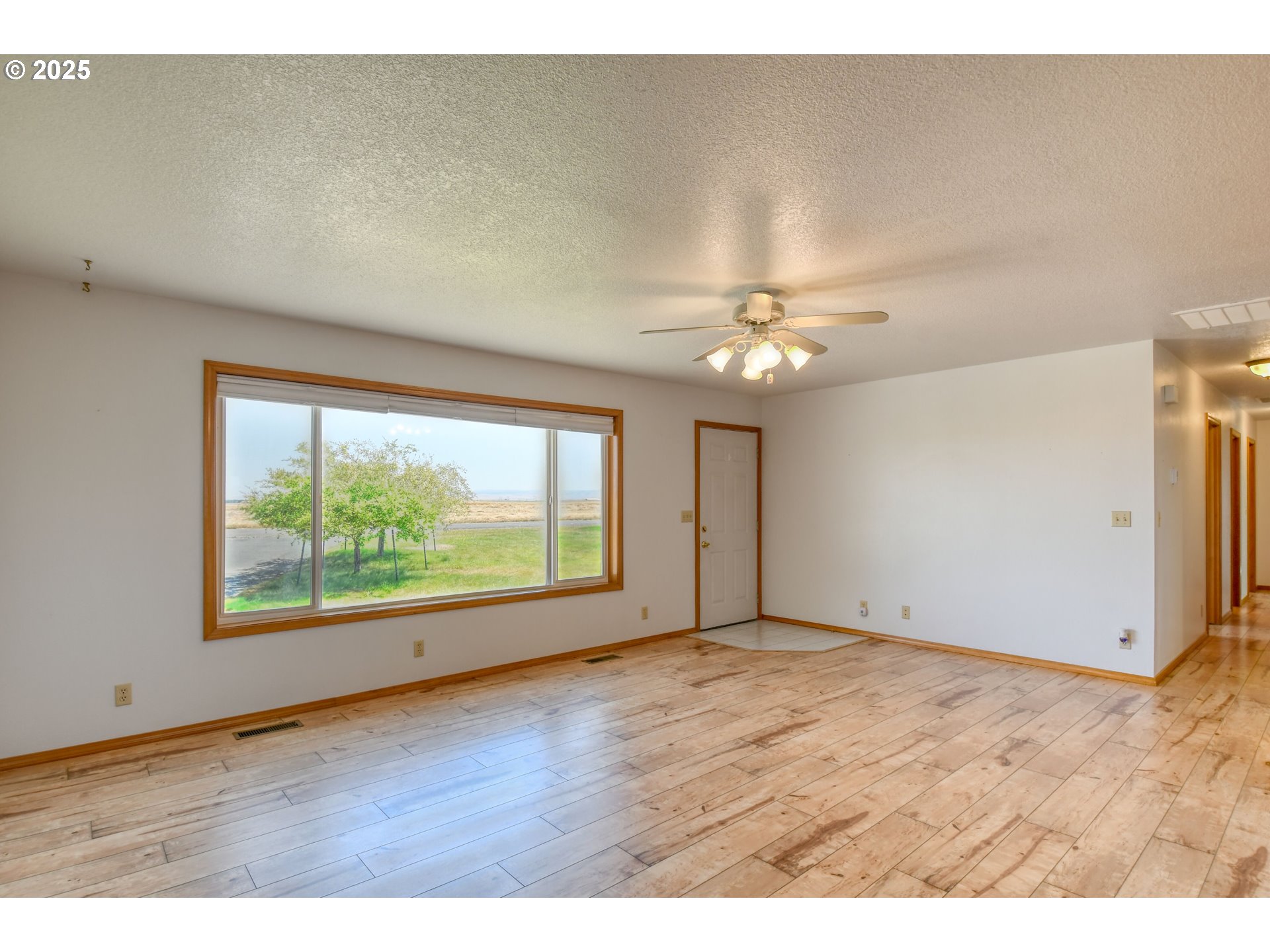 72062 Westfield Boulevard Pendleton, OR 97801 - Photo 3 of 48 an empty room with wooden floor and windows