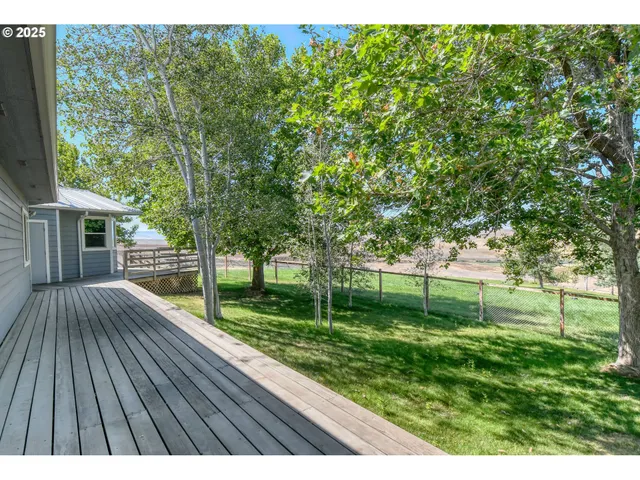 a view of backyard with garden and deck