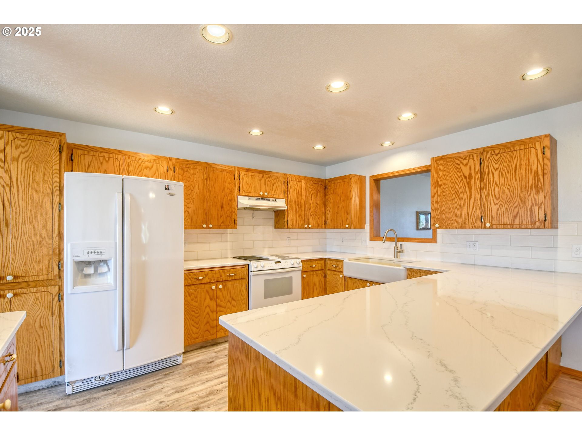 72062 Westfield Boulevard Pendleton, OR 97801 - Photo 7 of 48 a kitchen with stainless steel appliances granite countertop a refrigerator a sink a stove and white cabinets with wooden floor