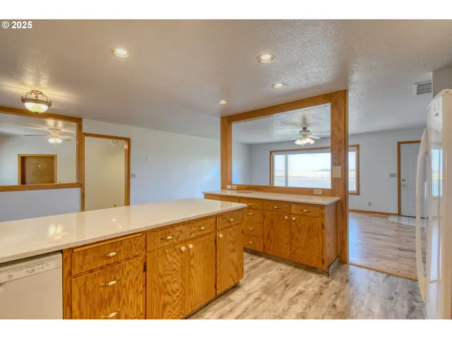 a large kitchen with stainless steel appliances granite countertop a sink and cabinets