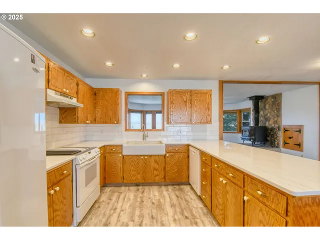 a kitchen with stainless steel appliances granite countertop a sink and cabinets