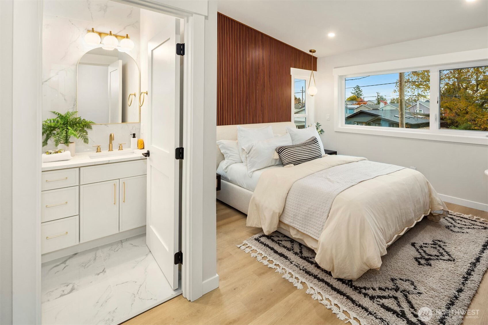 9205 Evanston Avenue North Seattle, WA 98103 - Photo 13 of 21 a bedroom with a large bed and a potted plant