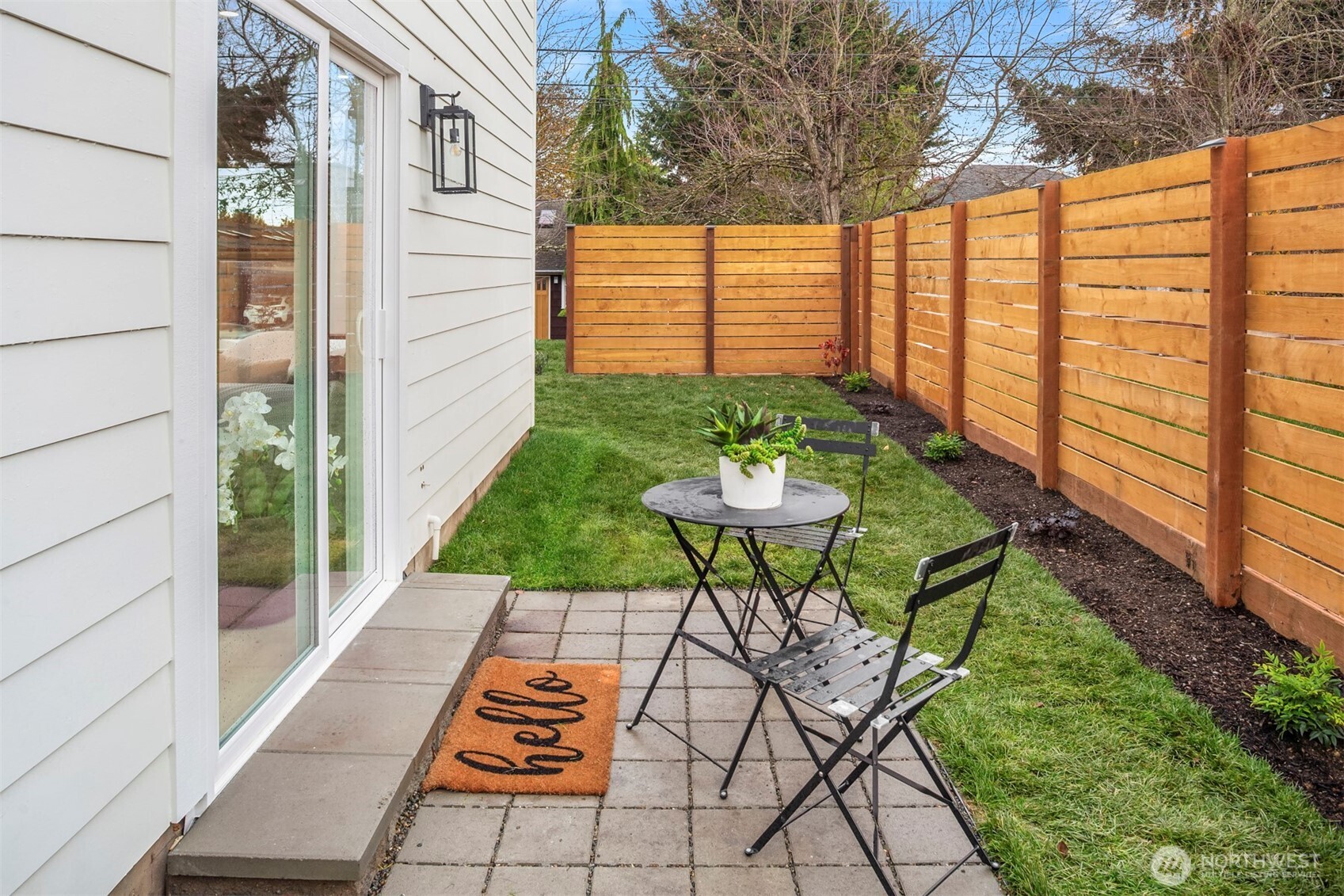 9205 Evanston Avenue North Seattle, WA 98103 - Photo 16 of 21 a view of a patio with a table and chairs and potted plants