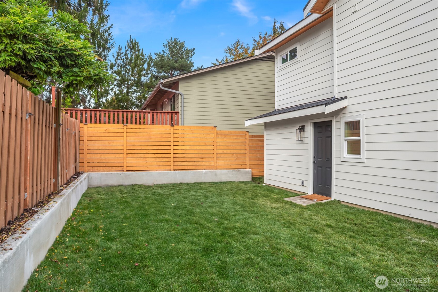 9205 Evanston Avenue North Seattle, WA 98103 - Photo 18 of 21 a view of a backyard with wooden fence