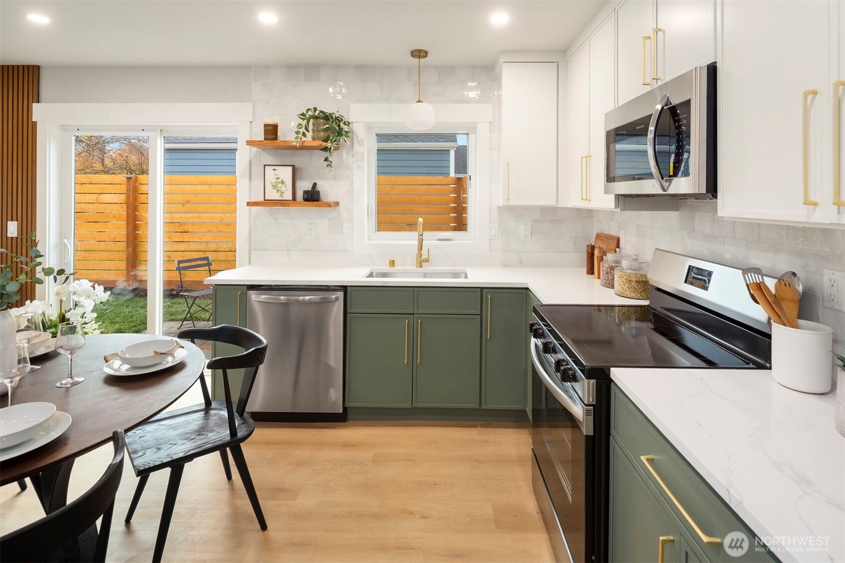 9205 Evanston Avenue North Seattle, WA 98103 - Photo 6 of 21 a kitchen with a stove a sink and a refrigerator
