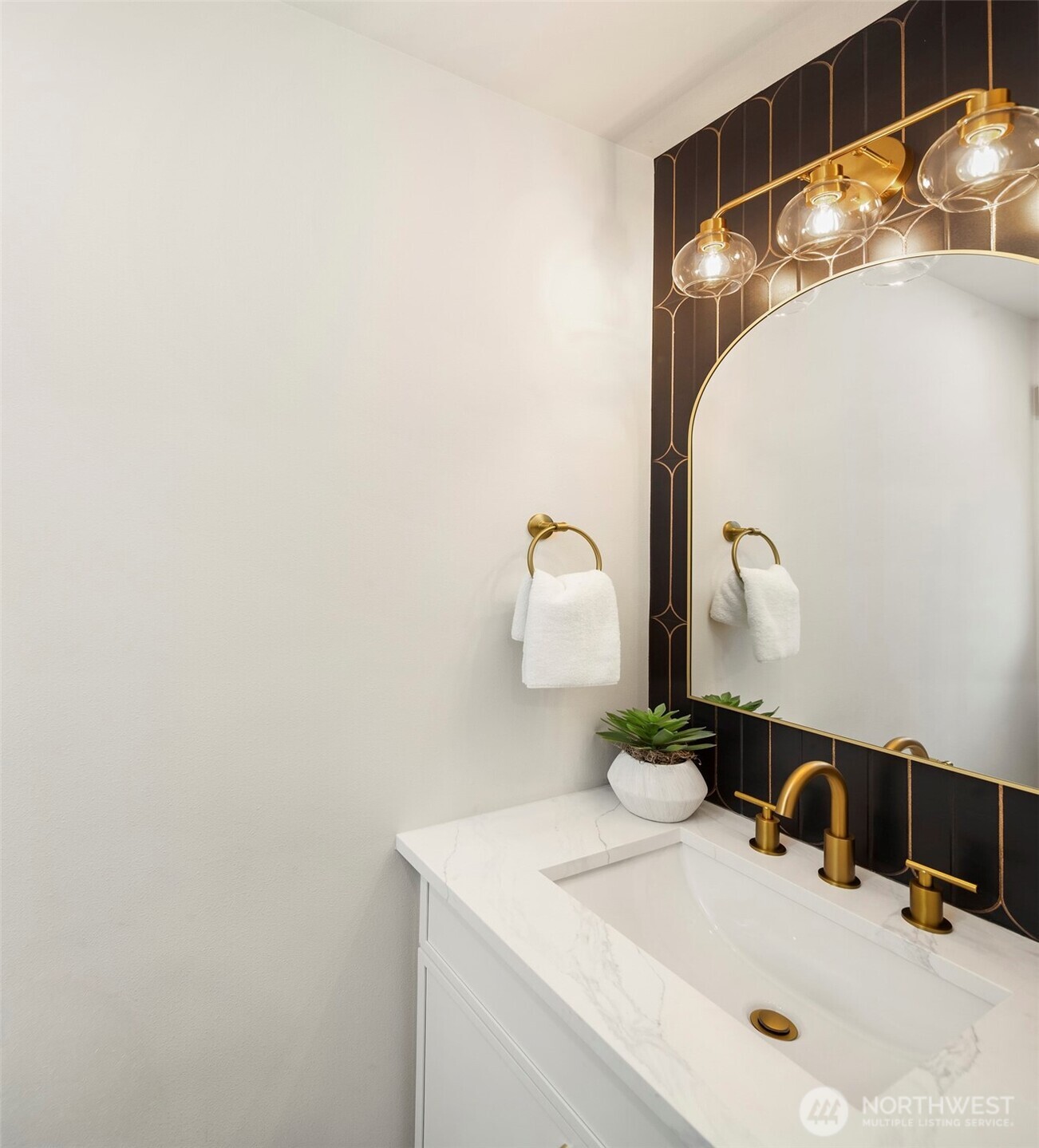 9205 Evanston Avenue North Seattle, WA 98103 - Photo 7 of 21 a bathroom with a sink and a mirror