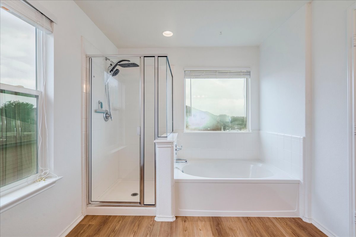 401 Waterleaf Boulevard Kyle, TX 78640 - Photo 16 of 28 Primary bathroom with garden tub and standalone shower
