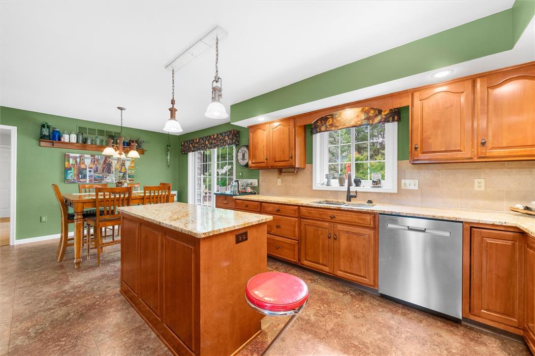 5616 Snowdrift Road Orefield, PA 18069 - Photo 5 of 36 A well-equipped kitchen and dining area features abundant cabinetry, a central island, and a dining set.