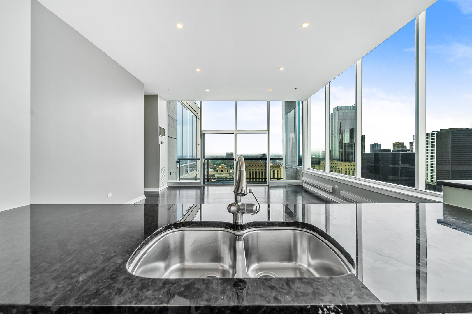 611 South Wells Street, Unit 3102 Chicago, IL 60607 - Photo 13 of 33 a kitchen with kitchen island a large window sink and cabinets