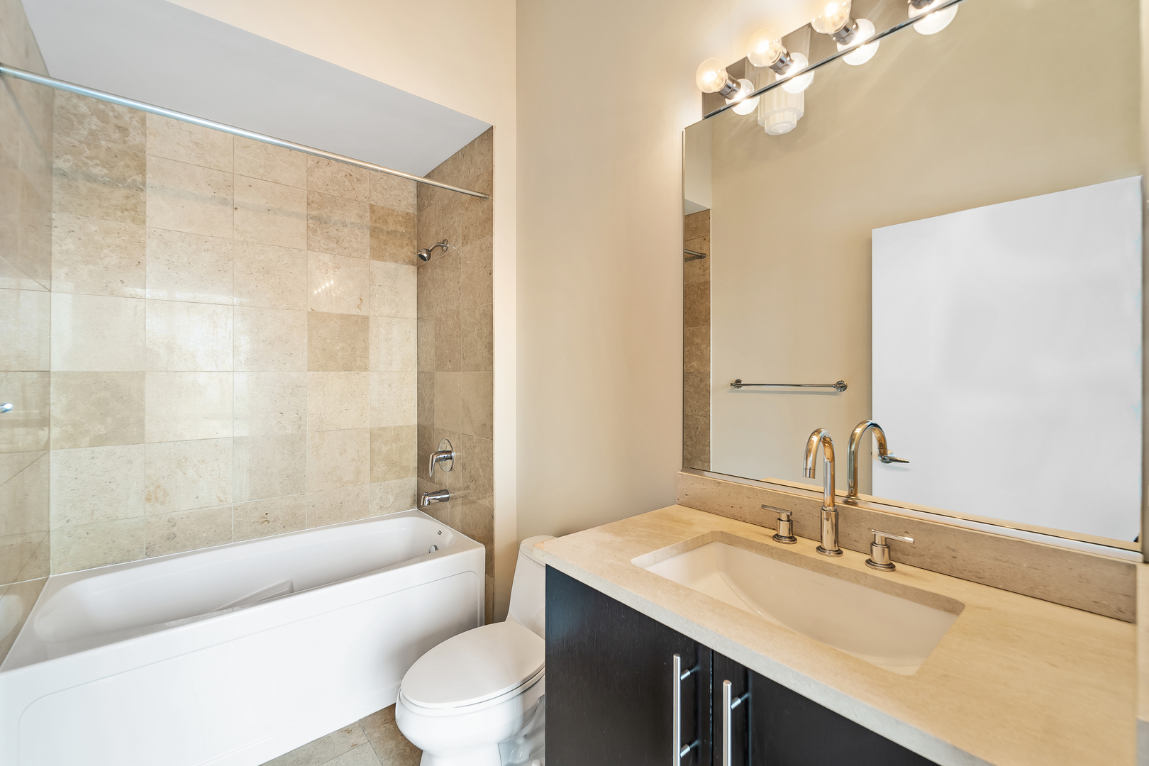 611 South Wells Street, Unit 3102 Chicago, IL 60607 - Photo 22 of 33 a bathroom with a granite countertop sink a toilet and shower