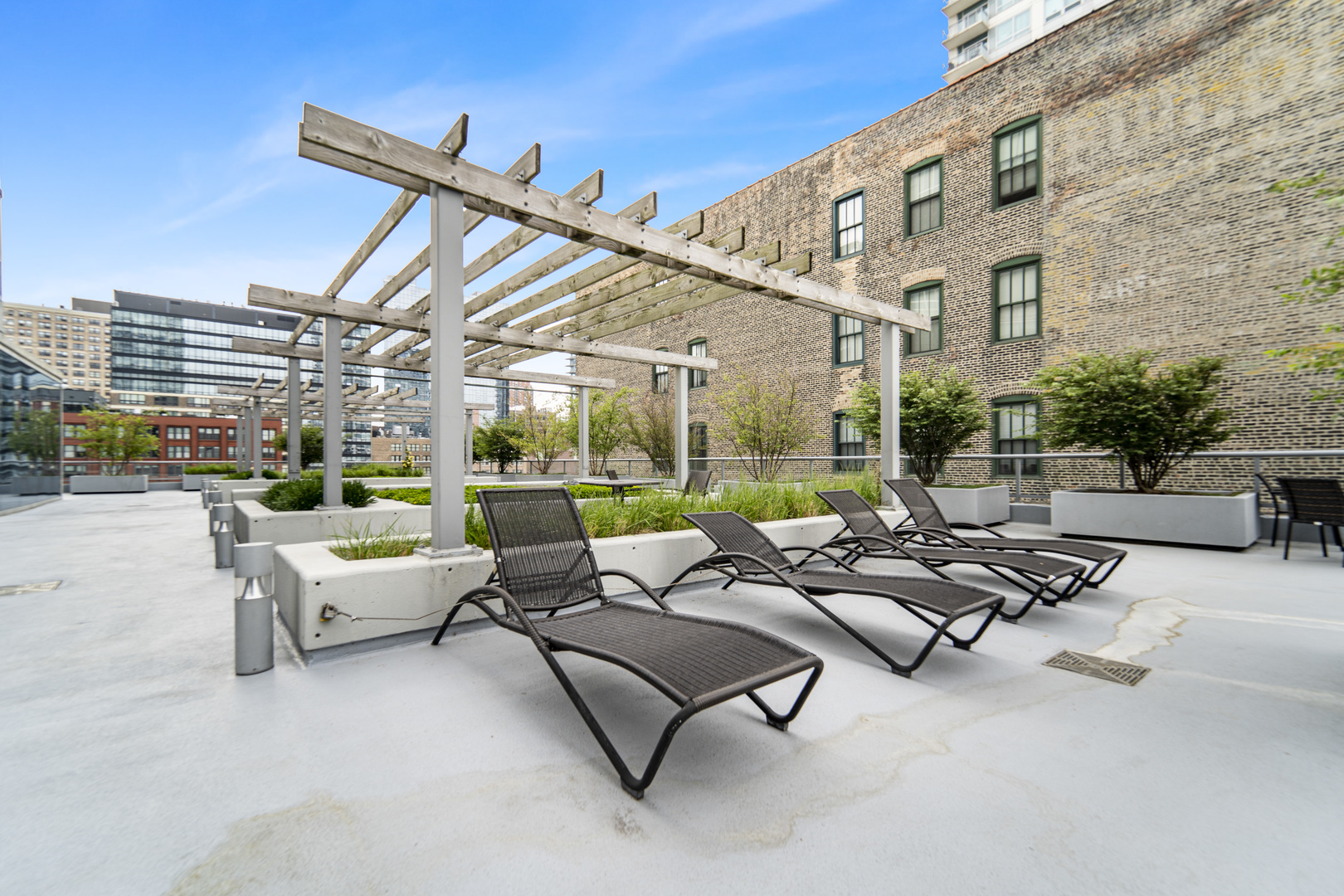 611 South Wells Street, Unit 3102 Chicago, IL 60607 - Photo 29 of 33 a building outdoor space with patio furniture and a patio