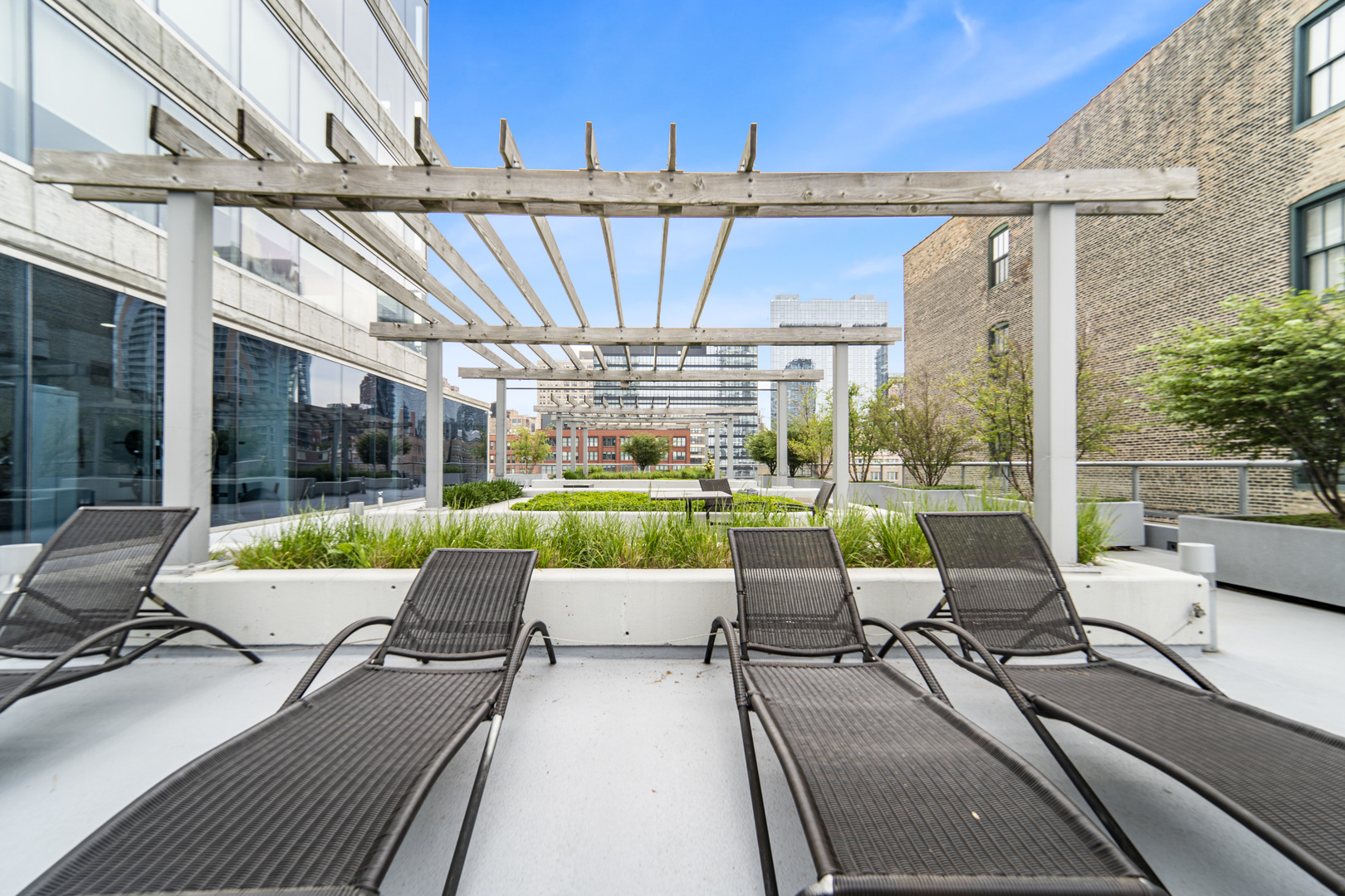 611 South Wells Street, Unit 3102 Chicago, IL 60607 - Photo 30 of 33 a view of a patio with couches table and chairs and potted plants