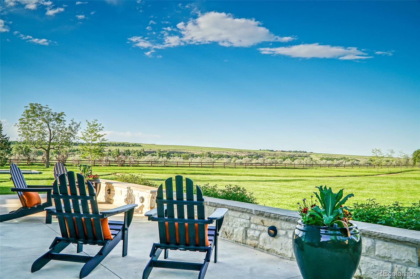 7983 Valmont Road Boulder, CO 80301 - Photo 2 of 31 a view of a chairs and table in patio with a lake view