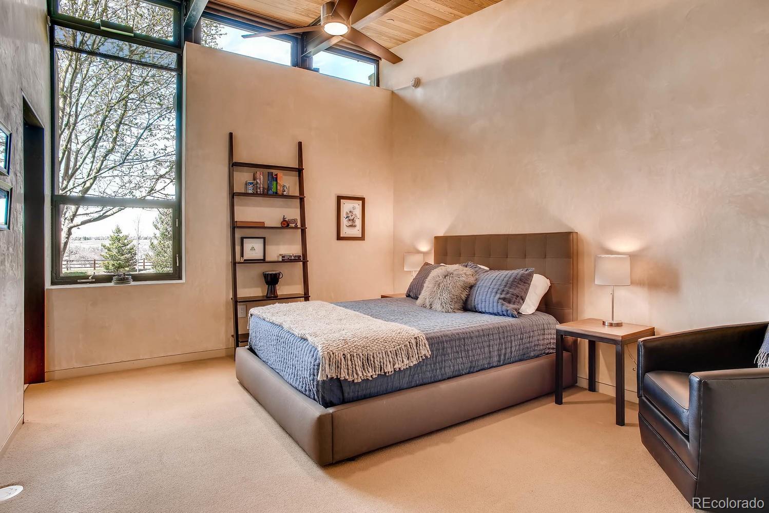 7983 Valmont Road Boulder, CO 80301 - Photo 25 of 31 a spacious bedroom with a bed and a window