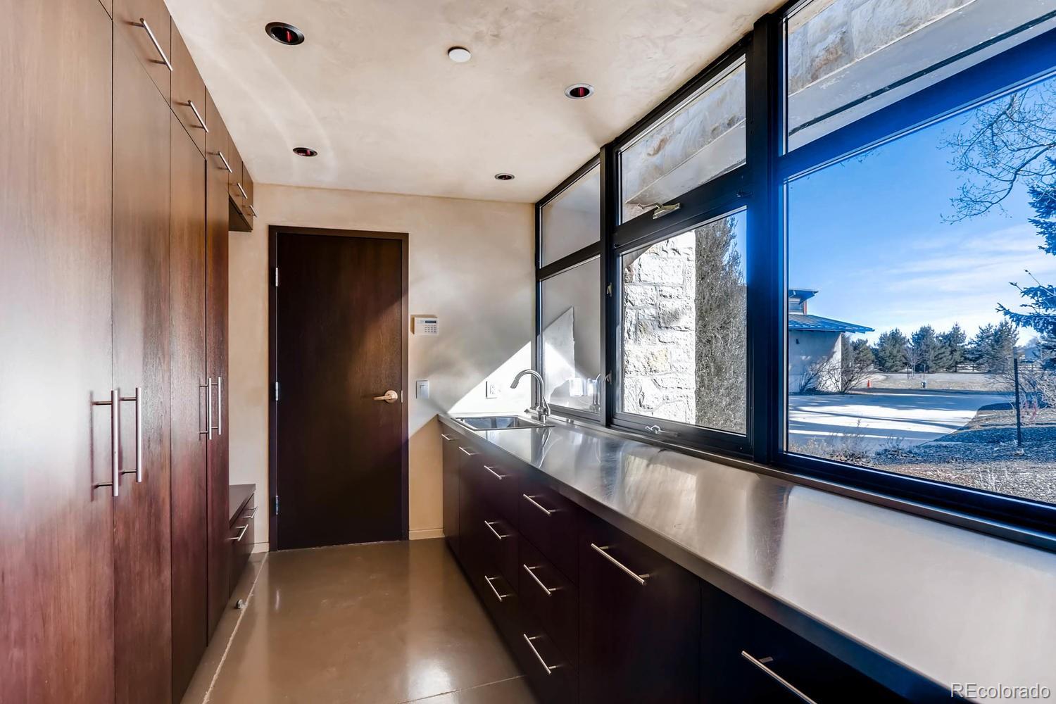 7983 Valmont Road Boulder, CO 80301 - Photo 27 of 31 a kitchen with granite countertop a sink and a large window